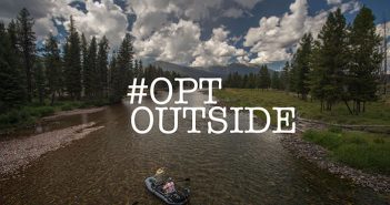 A man in a boat on a river with the words opt outside.