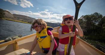 Two girls in a canoe.