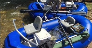 Two rafts on a river with a man fishing.