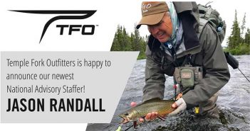 A man holding a fish with the words tfo.