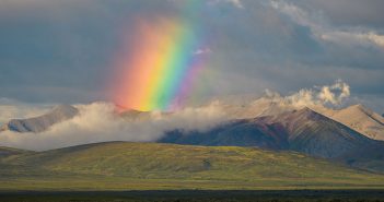 A rainbow over a mountain range.