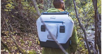 A man with a backpack in the woods.