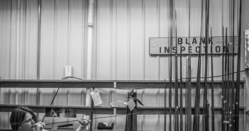 Black and white photo of a woman working in a workshop.