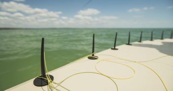 A fishing boat with a fishing pole attached to it.