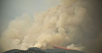 A smoke billowing out of a mountain.