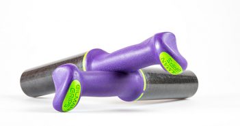 A pair of purple and green dumbbells on a white background.