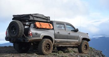 A toyota tacoma is parked on top of a mountain.