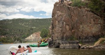 A group of people on rafts on a river.