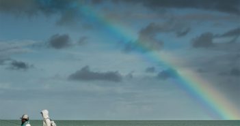 The cover of angling magazine with a rainbow in the background.