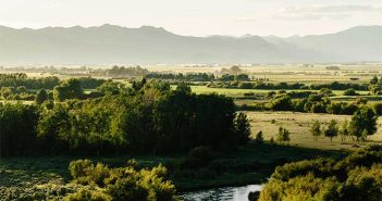 A river and mountains with the words 1 % for the planet.