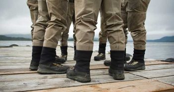 A group of men standing on a dock.