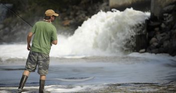 A man is fishing in a river.