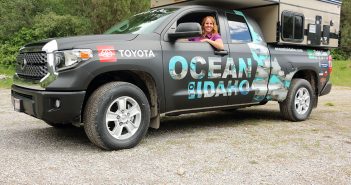 A toyota tundra truck with a tent in the back.