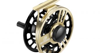 A gold and black fly reel on a white background.