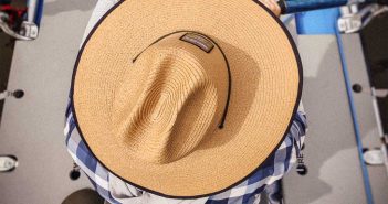 A man wearing a hat on a boat.