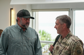 Two men in military uniforms talking to each other.