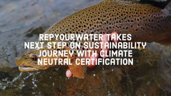 A person is holding a trout in the water with the words, rewrite writer takes next step on sustainability journey with climate neutral certification.