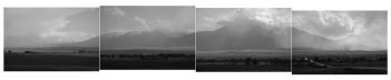 A black and white image of mountains and clouds.