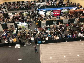 A large crowd of people at a convention.