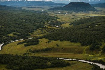 An aerial view of a valley with a river running through it.