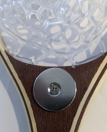 A tennis racket with a button on it.