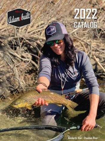 A woman holding a fly fishing net in the water.