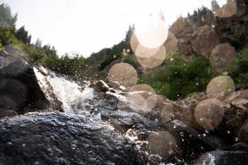 A stream of water flowing over rocks.