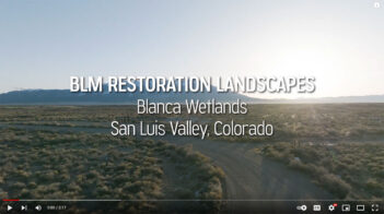 A view of the Blanca Wetlands in San Luis Valley, Colorado, at sunset, with a dirt road and vegetation in the foreground. Text overlay reads, "BLM Restoration Landscapes Blanca Wetlands San Luis Valley, Colorado.