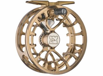 A gold-colored, intricately designed fishing reel with an open frame structure and a logo in the center.