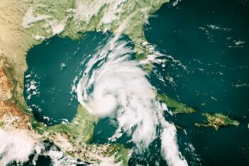 Satellite image of a swirling hurricane over the Gulf of Mexico, approaching the southeastern United States and parts of the Caribbean.