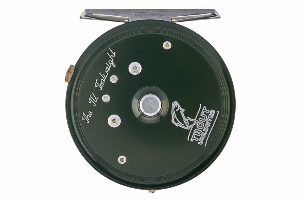 Green fly fishing reel with "The M. Godlight" and "Trout Unlimited" inscriptions, featuring a fish logo.