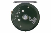 Green fly fishing reel with "The M. Godlight" and "Trout Unlimited" inscriptions, featuring a fish logo.