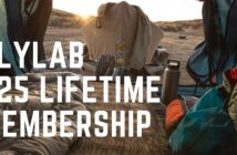 Camping gear inside a tent with a view of the sunrise. Text reads, "Flylab $25 Lifetime Membership.